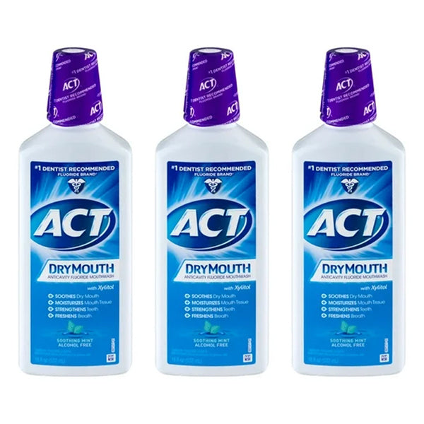 Three bottles of ACT Dry Mouth Fluoride Mouthwash, Soothing Mint flavor (18oz each), are arranged side by side. This product comes in a 3 pack and is alcohol free.